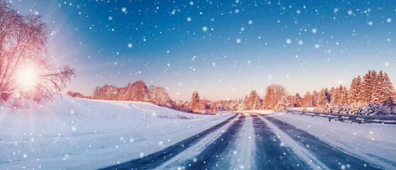 Beautiful winter road in natural sunny park.