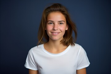Fototapeta premium Portrait of a cute fictional white teenager girl smiling candidly. Isolated on a plain colored background. Generative AI. 