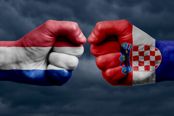 FRANCE vs CROATIA confrontation, religious conflict. Men's fists with painted flags of FRANCE and CROATIA.