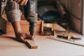 close-up hand a Young man Carpenter works on woodworking machinery in a carpentry shop. The...