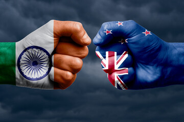 INDIA vs NEW ZEALAND confrontation, religious conflict. Men's fists with painted flags of INDIA and...