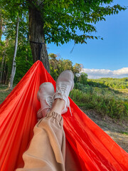 pov woman resting in hammock in forest