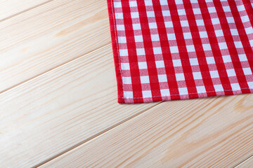 Obraz premium Red Checkered napkin on wooden background