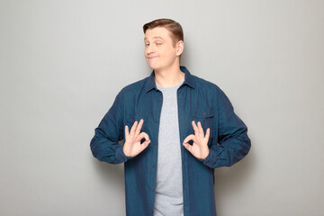 Portrait of happy mature man showing okay gestures and smiling