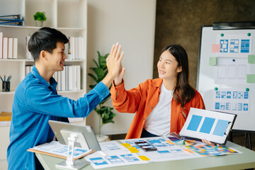 Asian businessman and woman people meeting in office. Employee brainstorm and work as team, plan and discuss project by point on paper and tablet.