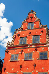 Colorful stepped gable facade of historic building on Stortorget public square in Gamla Stan, the...