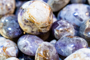 Closeup of various colorful stones quartz, marbles, ore minerals, gems use as ornament and decoration jewelry that contain spiritual force human believes