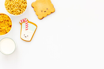 Flat lay of food for kids - milk with cornflakes and biscuits, top view