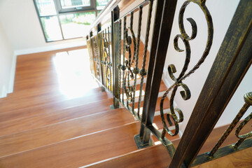 internal spiral staircase has a wooden floor and ornate wrought iron balustrade with wooden...