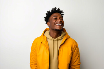 Man with yellow jacket laughing and looking up. - Powered by Adobe