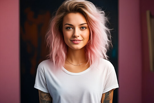 Woman with pink hair and tattoos on her arm.