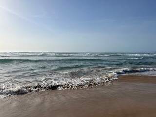 Waved ocean bay, sandy coast