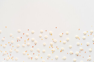 White sugar sweet snowflakes sprinkles on white background. Sweet backing decoration for cake and candy.Copy space.  - obrazy, fototapety, plakaty