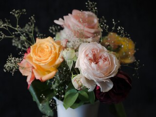 a bouquet of flowers in a white vase on a table