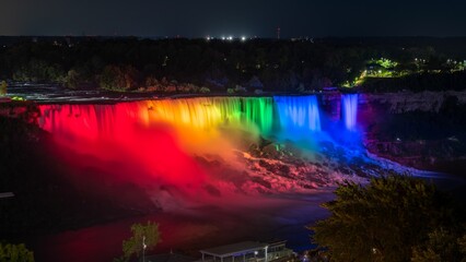 Stunning view of The American Falls lit up by the nightly light show, Niagara Falls, Canada