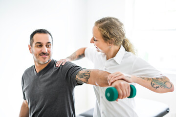 Modern rehabilitation physiotherapy woman with man client