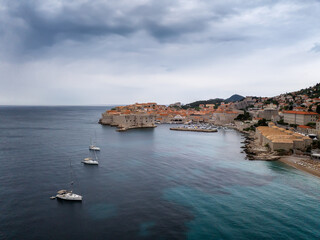 Fototapeta premium Amazing panoramic view of the famous city of Dubrovnik in Croatia, old town with city walls, houses with red roofs, historical buildings surrounded by turquoise sea