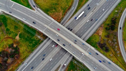 Aerial view massive highway intersection, stack interchange with elevated road junction overpass at early morning in American. This five-level freeway interchange carry heavy traffic, panorama. - obrazy, fototapety, plakaty