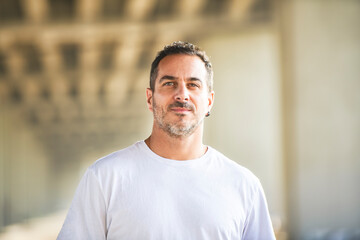 Obraz premium portrait caucasian man outside on industrial urban background