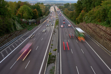 Long exposure photo of traffic with blurred traces from cars, top view. road, cars, blurred traffic, evening, top view. Highway at evening, blue hour illuminated by the traffic of cars
