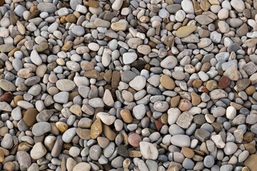 pebbles on a sunny day textured with a natural stone