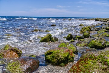 Fototapeta na wymiar Scenic view of a rocky shoreline in a tranquil blue seascape