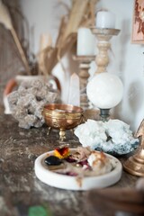 Closeup of a  wooden table with a bowl of assorted dried flowers  under the natural light