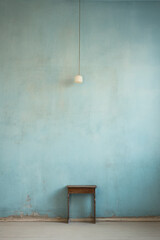 Blue and rough texture background with blank wallpaper with ceiling lamp and table. Worn wall and peeling paint.