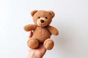 hand hold brown toy bear