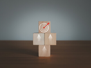 Arrow pointing to target on wooden block