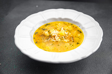 soup broth vegetables with rice, potatoe, carrot, onion eating cooking appetizer meal food snack on the table copy space food background rustic top view 