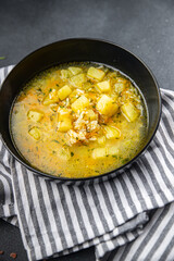 soup broth vegetables with rice, potatoe, carrot, onion eating cooking appetizer meal food snack on the table copy space food background rustic top view 