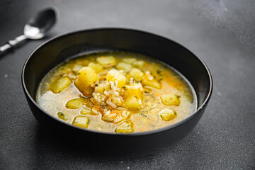 soup broth vegetables with rice, potatoe, carrot, onion eating cooking appetizer meal food snack on the table copy space food background rustic top view 