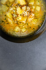 soup broth vegetables with rice, potatoe, carrot, onion eating cooking appetizer meal food snack on the table copy space food background rustic top view 