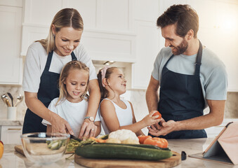Love, cooking and family in the kitchen together for bonding and preparing dinner, lunch or supper. Happy, smile and girl children cutting vegetables or ingredients with parents for a meal at home.