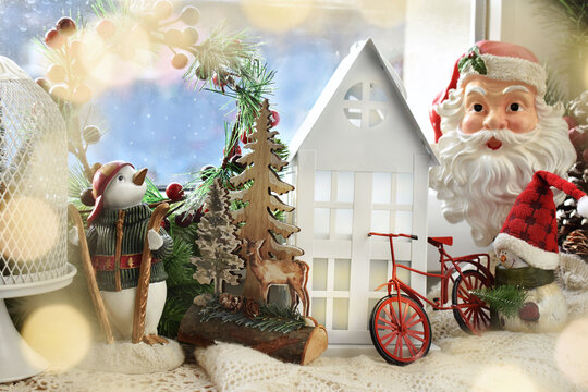 Christmas window decoration with winter scenery and seasonal figurines