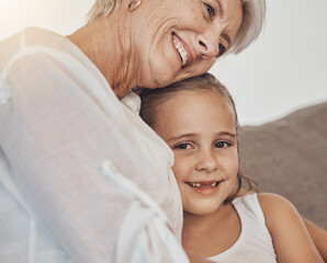 Love, hug and girl child with grandmother on a sofa hug, bonding and relax in their home together....