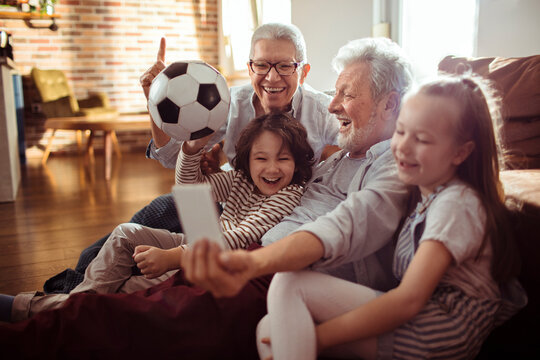 Skipped Generation Family Using A Smartphone Together At Home