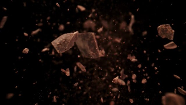 Super Slow Motion Shot of Raw Chocolate Chunks Flying Towards Camera at 1000fps.