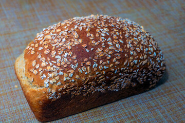 fresh baked oatmeal loaf lies on the table