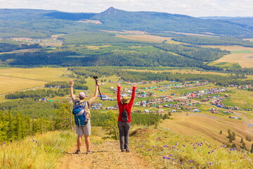 man and woman Tourists on a picnic on the ridge of the Ural Mountains on a summer sunny day