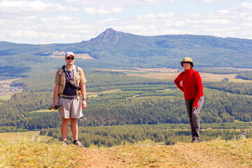 man and woman Tourists on a picnic on the ridge of the Ural Mountains on a summer sunny day