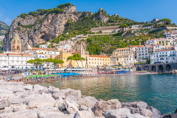 City of Amalfi Italy with the water and beach and old city with the mountain in the background