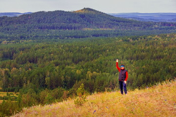 beautiful mature woman traveler enjoys the nature of the southern Urals