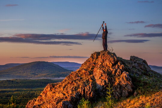 young handsome man Tourist travels along the rocks of the Southern Urals on a summer day