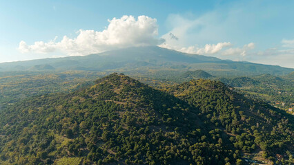 Nicolosi, Sicily, Italy. Volcanic craters overgrown with forest on the slopes of Mount Etna, Aerial...