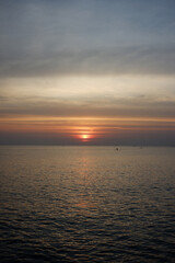 The sea at sunset is close to the edge of the sea.