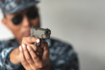 Police cop constable holding Pistol Is preparing to shoot bandit culprit in abandon building. Cop...