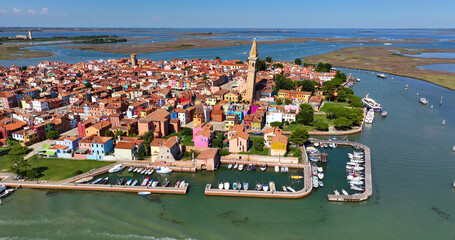 Aerial view of Burano Island, Church of Saint Martin Bishop, Campanile Pendente, colorful houses, fishing port, Veneto Region, Italy