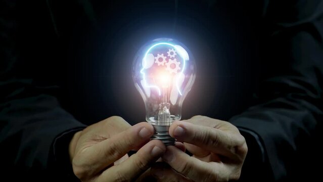 Business man, who handle the light bulb, inside showing human brain thinking about technology functional.